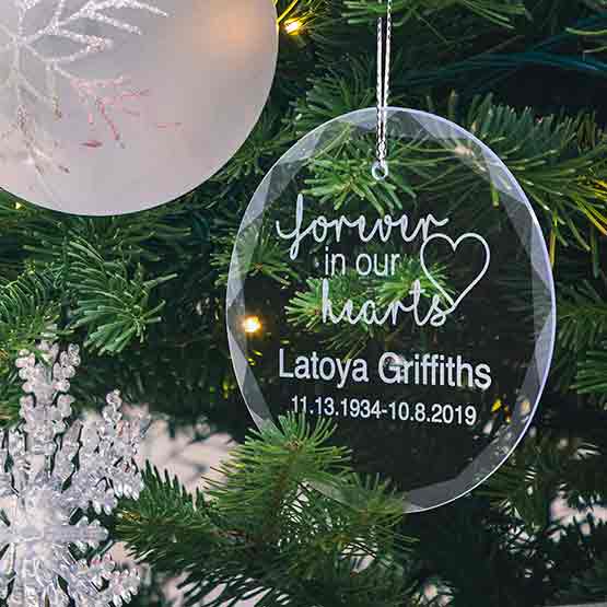 Circle Glass Christmas Ornament Engraved With Forever In Our Hearts And Name And Years Lived Hanging On Christmas Tree