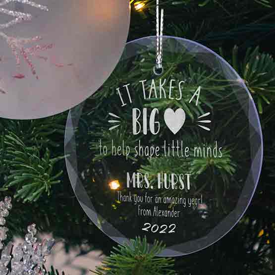 Custom Circle Glass Ornament Engraved With It Takes A Big Heart Teacher Appreciation Message Hanging On A Christmas Tree