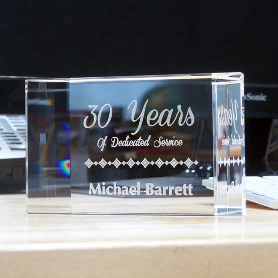 Custom Faceted Glass Paperweight Engraved With Name And Years Of Service Text Freestanding On Office Desk With Monitor