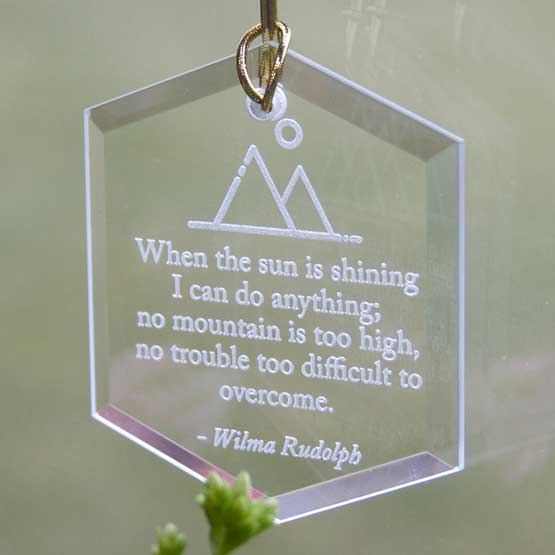 Custom Hexagon Glass Suncatcher Engraved With Mountain Art And Quote Hanging By Window Above Plants Via Gold String