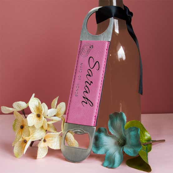 Stainless Steel And Pink Faux Leather Bottle Opener Engraved With Ring Art And Sarah And Maid Of Honor Leaning Against Beer