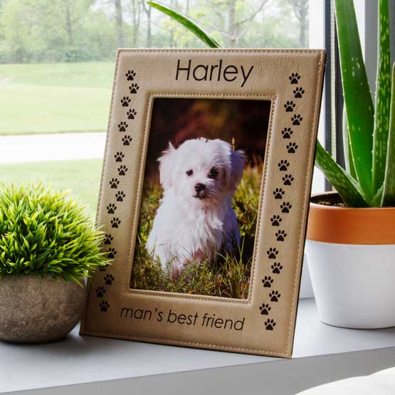Light Brown Faux Leather Picture Frame With Dog Photo And Engraved With Name And Man’s Best Friend On Window Sill With Plants