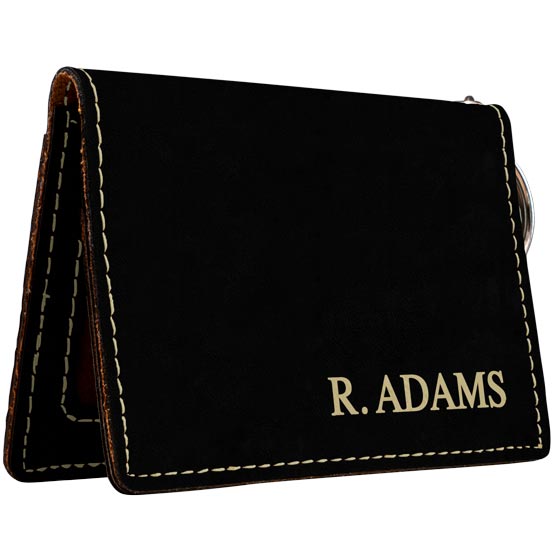 Custom Black And Gold Faux Leather Keychain Wallet ID Holder Laser Engraved With Name Against A White Background
