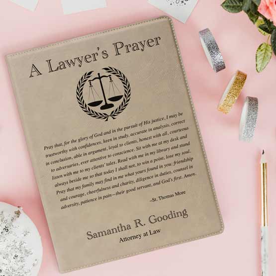 Custom Light Brown Faux Leather Notebook Engraved With Name And Justice Logo And Complete Lawyer’s Prayer On Pink Table