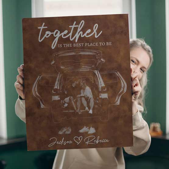 Young Woman Holding Rustic And Silver Faux Leather Wrapped Rectangle Canvas Engraved With Couple Photo And Romantic Message