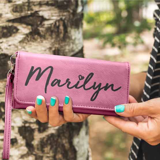 Woman Hands Outdoors Holding Custom Pink Faux Leather Trifold Wallet With Wrist Strap And Laser Engraved With Name