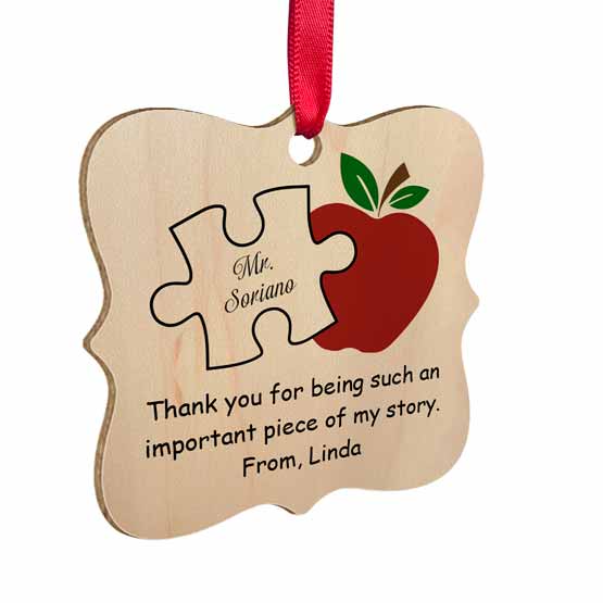 Ornate Maple Wood Ornament With Red Ribbon And Printing Of Puzzle Piece And Apple And Teacher Name And Thank You Message