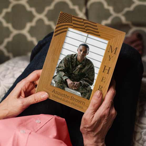 Woman Hands Holding Red Alder Photo Frame With Soldier Photo And Engraved With American Flag And My Hero And Soldier Details
