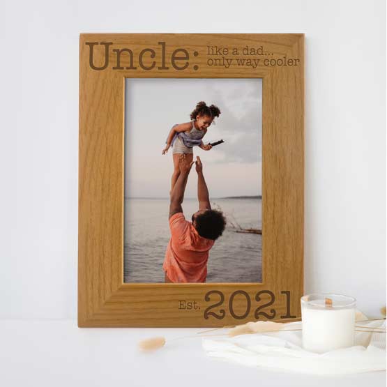 Red Alder Picture Frame With Photo Of Uncle And Kid At Lake And Engraved With Date And Cool Uncle Message On Shelf By Candle