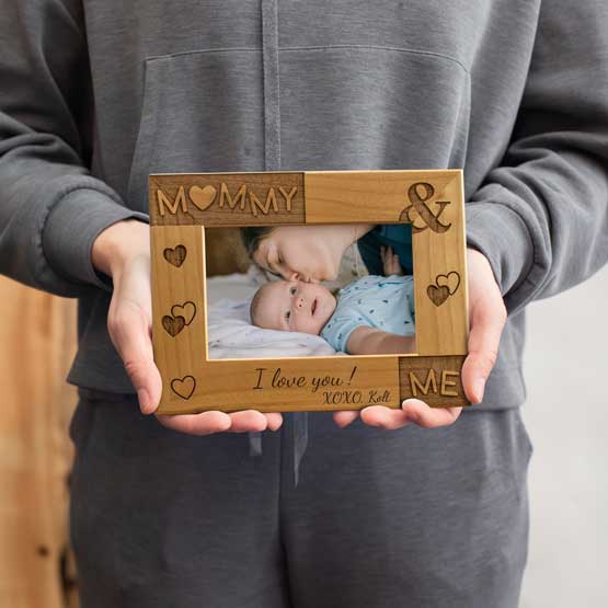 Woman Holding Red Alder Picture Frame With Photo Of Mom And Baby And Engraved With I Love You Message And Mommy And Me