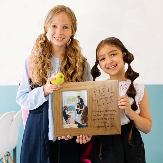 Little Girls Holding Red Alder Picture Frame With Teacher Photo And Engraved With Puzzle Piece Art And Thank You Message