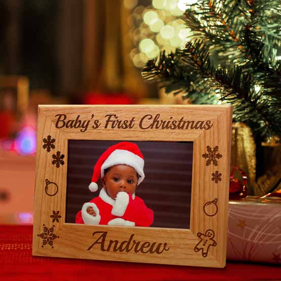 Red Alder Picture Frame With Baby Santa Photo And Engraved With Baby’s First Christmas And Holiday Art On Shelf By Gift
