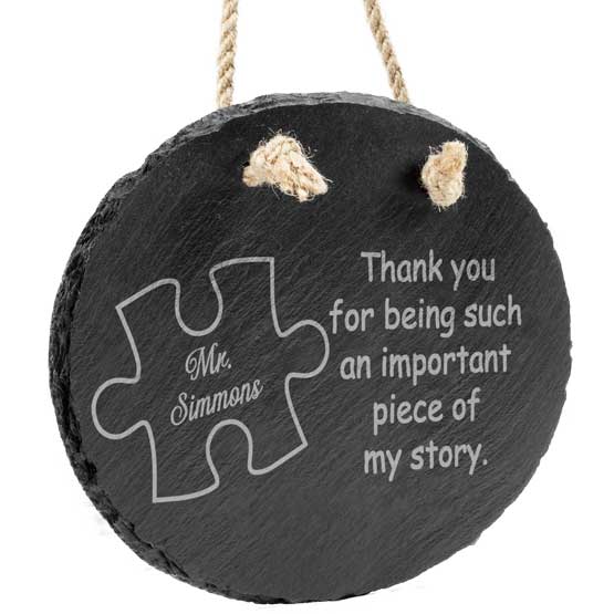 Custom Slate Oval Sign Printed With Puzzle Piece Art And Teacher Thank You Message Hanging Via Rope Against White Background