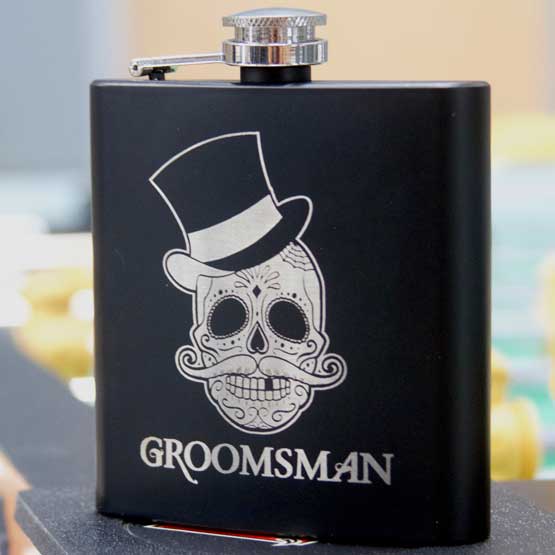 Custom Matte Black Stainless Steel Flask Engraved With Sugar Skull Wearing Top Hat And Groomsman On A Black Granite Counter