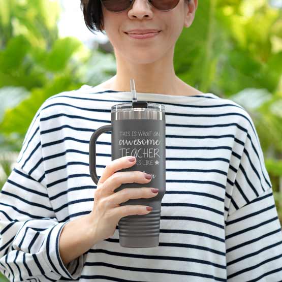 Happy Woman Outdoors Holding Custom Gray Stainless Steel Coffee Tumbler With Handle And Straw And Teacher Message