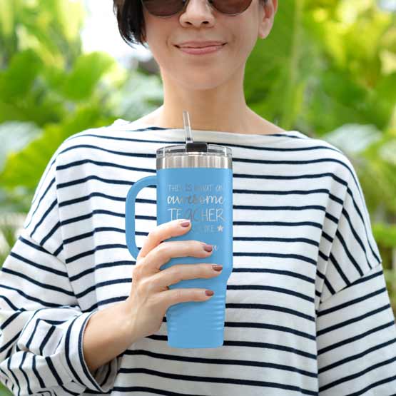 Happy Woman Outdoors Holding Custom Light Blue Stainless Steel Coffee Tumbler With Handle And Straw And Teacher Message
