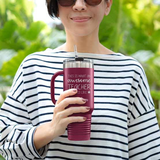 Happy Woman Outdoors Holding Custom Maroon Stainless Steel Coffee Tumbler With Handle And Straw And Teacher Message