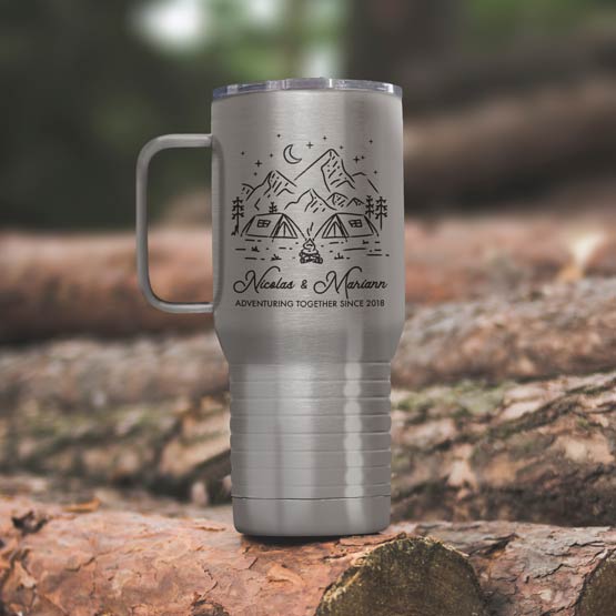 Stainless Steel Coffee Tumbler With Handle And Engraving Of Camping Art And Names And Date On Wood Log Outdoors
