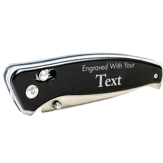 Black Stainless Steel Folding Knife With Button Lock In A Closed Position And Laser Engraved To Show Customizable Areas