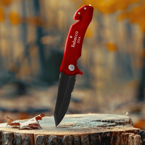 Custom Red Stainless Steel Rescue Knife In Open Position And Laser Engraved With Rebecca 2024 And Piercing A Log Outdoors