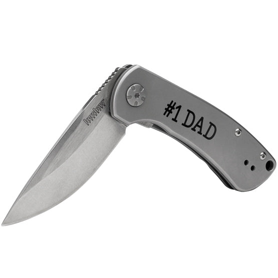 Custom Stainless Steel Folding Knife Opened Up And Laser Fused With Number One Dad Message On Handle Against White Background