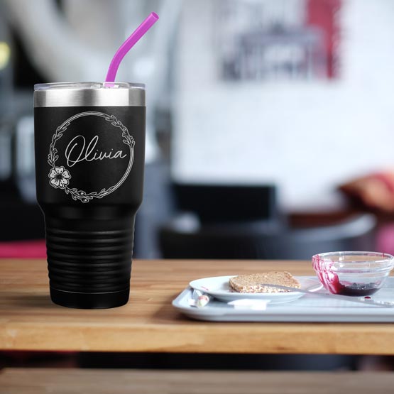 Custom Black Thirty Ounce Coffee Tumbler With Straw And Engraved With Name Inside Flower Art On Table With Food Platter 