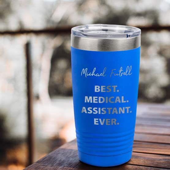 Custom Blue Stainless Steel Coffee Tumbler Engraved With Name And Best Medical Assistant Ever On Wood Table Outdoors
