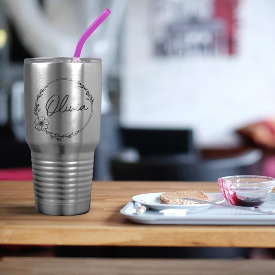 Thirty Ounce Stainless Steel Coffee Tumbler With Straw And Engraved With Name And Flower Art On Table With Food Platter