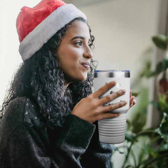 Woman In Santa Hat Near Christmas Tree Drinking From White Stainless Steel 30 Ounce Coffee Tumbler Engraved With Snowman Face