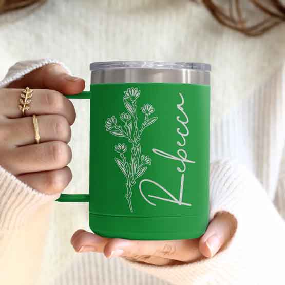 Woman Hands Holding Green Stainless Steel Coffee Tumbler Mug With Handle And Engraved With Name And Flower Art