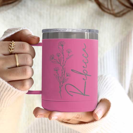 Woman Hands Holding Pink Stainless Steel Coffee Tumbler Mug With Handle And Engraved With Name And Flower Art