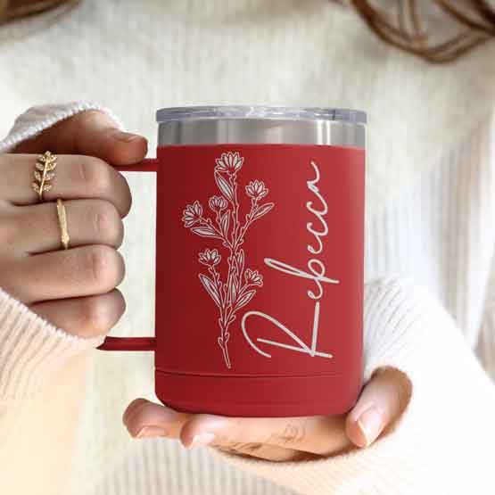 Woman Hands Holding Red Stainless Steel Coffee Tumbler Mug With Handle And Engraved With Name And Flower Art
