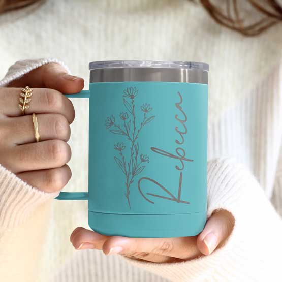 Woman Hands Holding Teal Stainless Steel Coffee Tumbler Mug With Handle And Engraved With Name And Flower Art