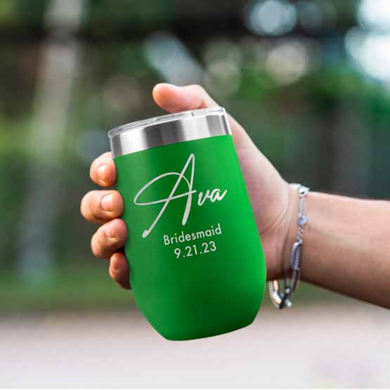 Woman Hand Outdoors Holding Custom Green Stemless Wine Tumbler Engraved With Name And Date And Bridesmaid Text