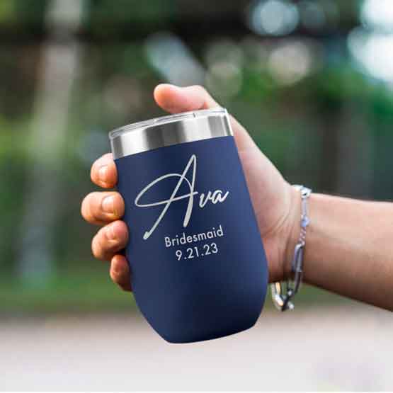 Woman Hand Outdoors Holding Custom Navy Blue Stemless Wine Tumbler Engraved With Name And Date And Bridesmaid Text