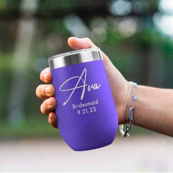 Woman Hand Outdoors Holding Custom Purple Stemless Wine Tumbler Engraved With Name And Date And Bridesmaid Text