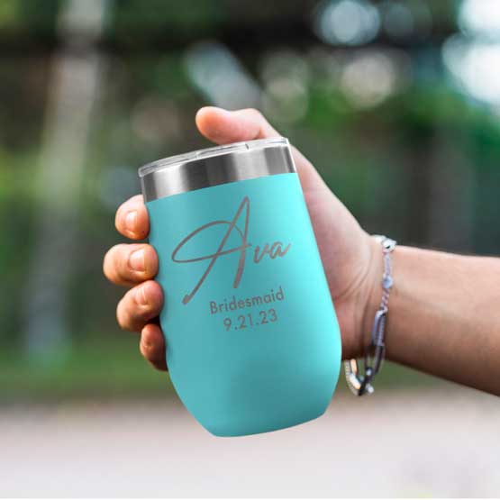 Woman Hand Outdoors Holding Custom Teal Stemless Wine Tumbler Engraved With Name And Date And Bridesmaid Text