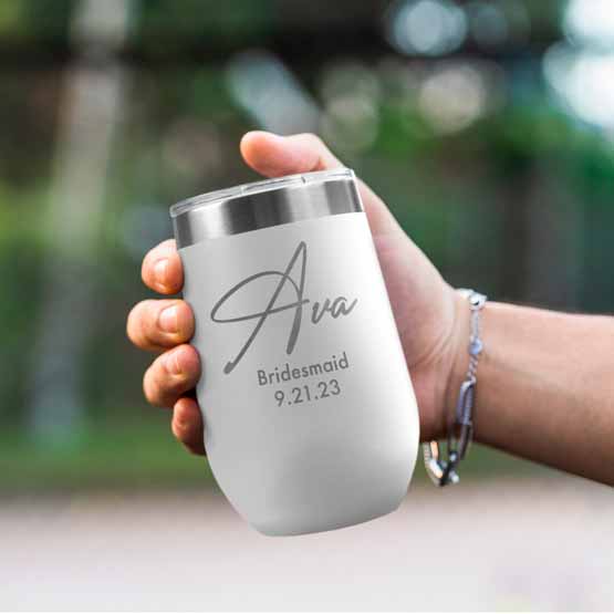 Woman Hand Outdoors Holding Custom White Stemless Wine Tumbler Engraved With Name And Date And Bridesmaid Text