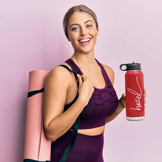 Woman In Workout Clothes Carrying Yoga Mat And Red Thirty Two Ounce Water Bottle With Straw And Engraved Name