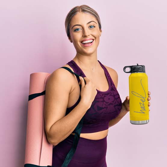 Woman In Workout Clothes Carrying Yoga Mat And Yellow Thirty Two Ounce Water Bottle With Straw And Engraved Name