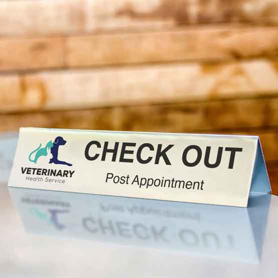 Custom printed sublimated aluminum table tent on reception table at vet's office.