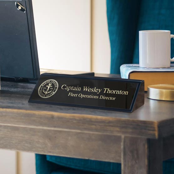 Desk Wedge With Black Piano Finish And Black Metal Plate Printed With Military Logo And Captain Details On Busy Office Desk