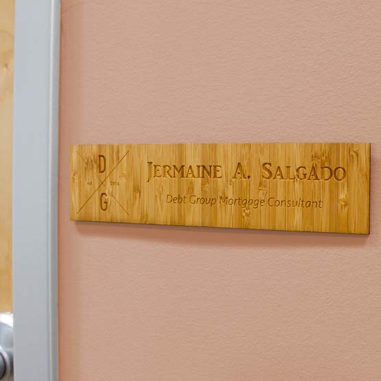 Custom Engraved Bamboo Wall Name Plate Near Door.