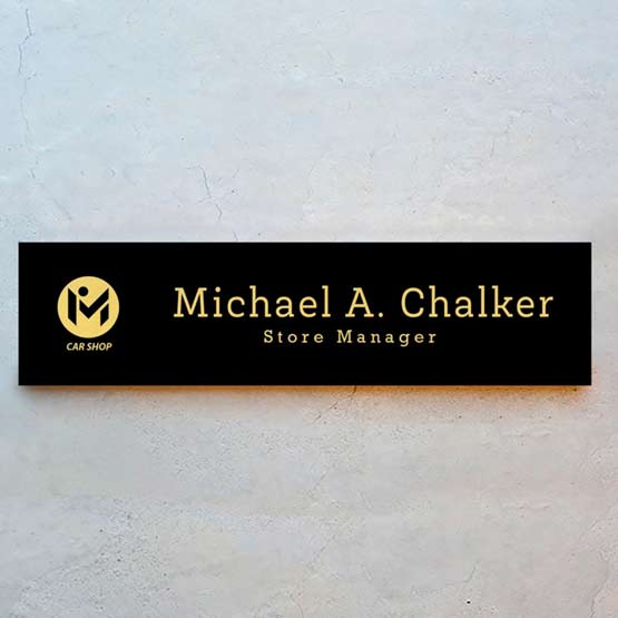 Custom Laser Engraved Aluminum Office Plate In Black Metal With Gold Engraving On Stone Wall.