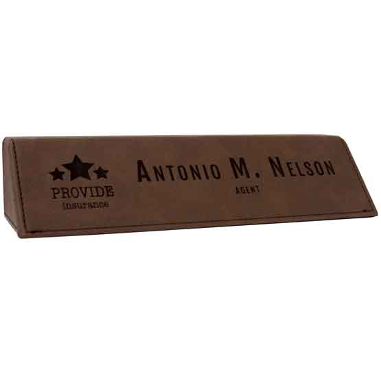 Dark Brown Faux Leather Desk Wedge Laser Engraved With Sample Logo And Employee Name And Role Against White Background