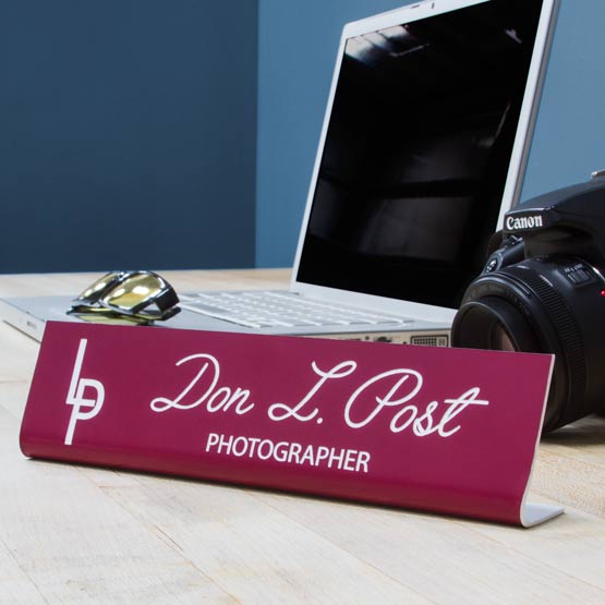 Custom Engraved Freestanding Plastic Desk Name Plate On Desk Near Camera.
