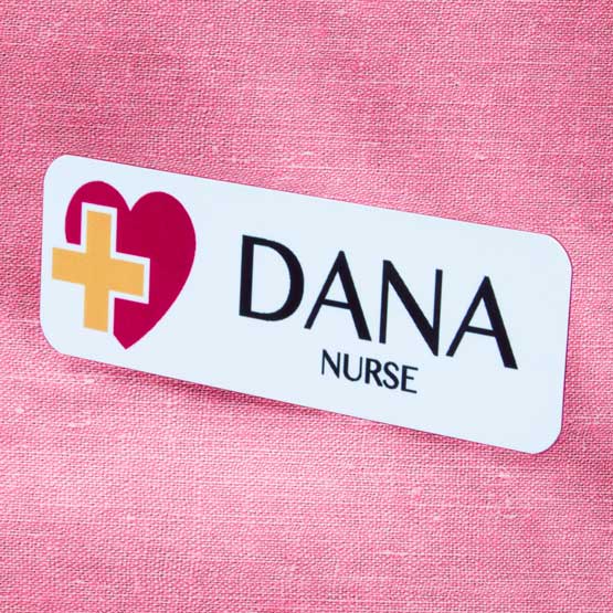 Full Color Metal Medical Name Tag For Dana The Nurse With Color Logo On Pink Shirt.