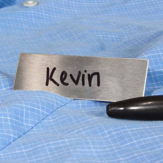 Custom Stainless Steel Name Tag With Rectangle Shape And Marked With Handwritten Kevin Text In Black On A Blue Dress Shirt