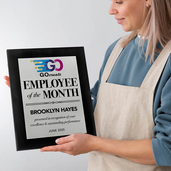 Smiling Woman Holding Custom Employee Of The Month Plaque With Logo For Brooklyn Hayes.