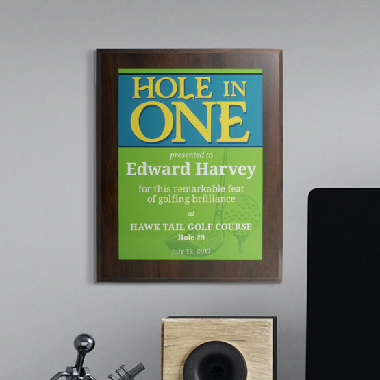 Hole In One Custom Golf Achievement Plaque Hanging On Gray Wall Above Desk.